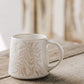 Berry Vine Driftwood Mug with botanical pattern on a rustic wood table