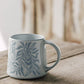 Berry Vine Ocean Mug with botanical pattern on a rustic wood table