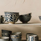 Posy Element mugs and bowls with bluebell floral pattern displayed on a shelf