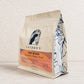 Angled view of The Bond medium roast coffee blend bag with caramelized brown sugar and milk chocolate tasting notes